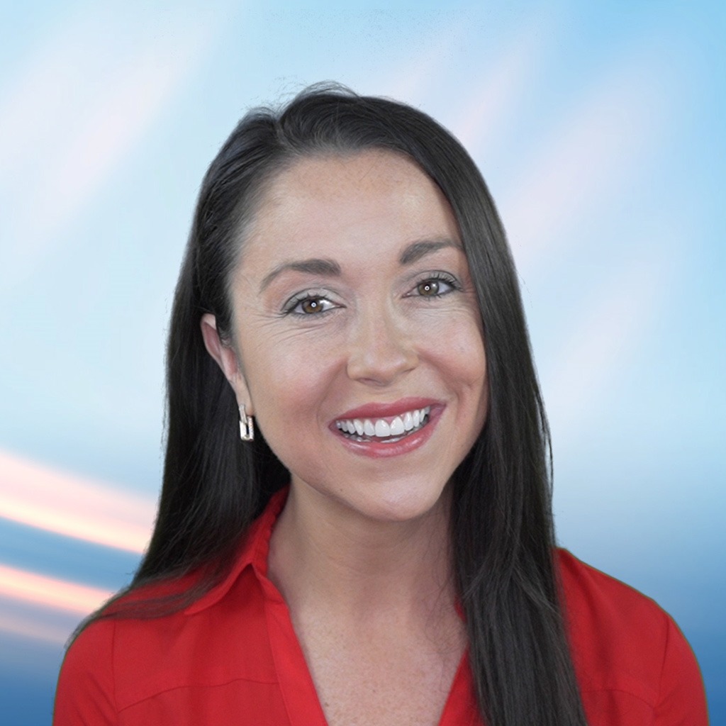 Professional woman with a confident smile against a blue sky background, ideal for business or corporate profiles.