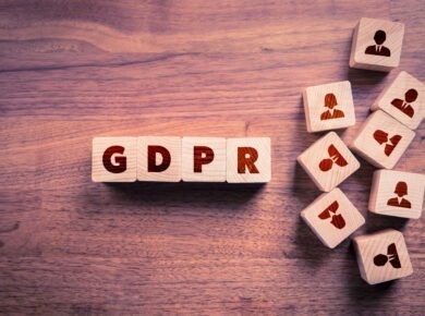 The image shows wooden blocks with the letters "GDPR," which stands for General Data Protection Regulation, a significant piece of European Union legislation aimed at protecting personal data and privacy.