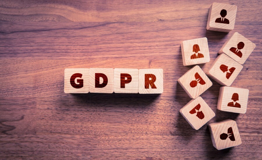 The image shows wooden blocks with the letters "GDPR," which stands for General Data Protection Regulation, a significant piece of European Union legislation aimed at protecting personal data and privacy.